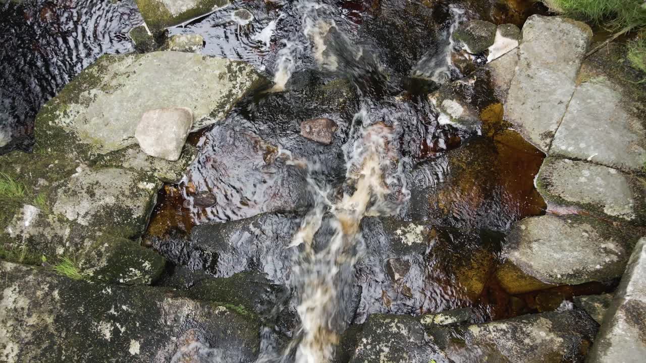 Beautiful Nature Scenery Of Turf Colored Stream In Wicklow Mountains, Ireland - top view zoom shot