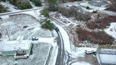 Car-driving-on-snow-covered-streets-during-a-blizzard