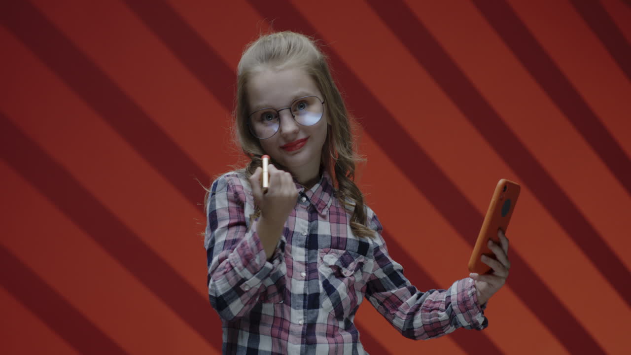 Girl Applying Lipstick and Taking a Selfie