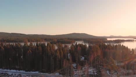 moving-backward-away-from-the-lake-with-icy-gravel-road-in-the-forground