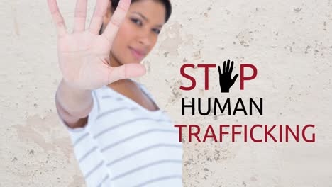 animation of stop human trafficking text over biracial woman with stop gesture