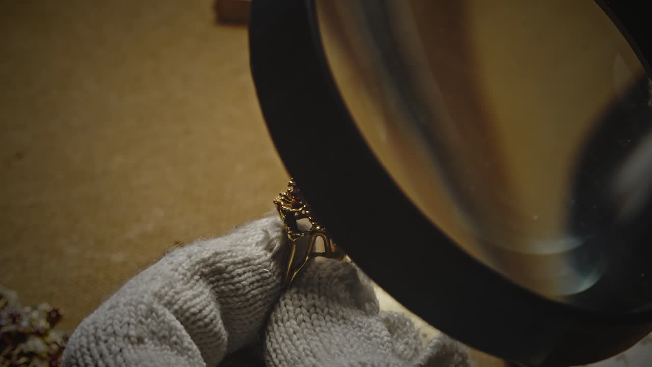 Jeweller analyses ring gemstones with magnifying glass loupe CLOSE-UP