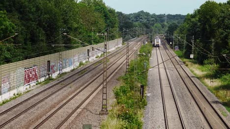 a series of railways with one train heading towards the camera can be set as a cloud shadow passes over