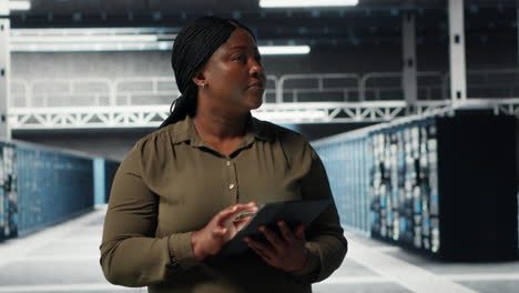 admin walking in data center, using tablet to manage software updates