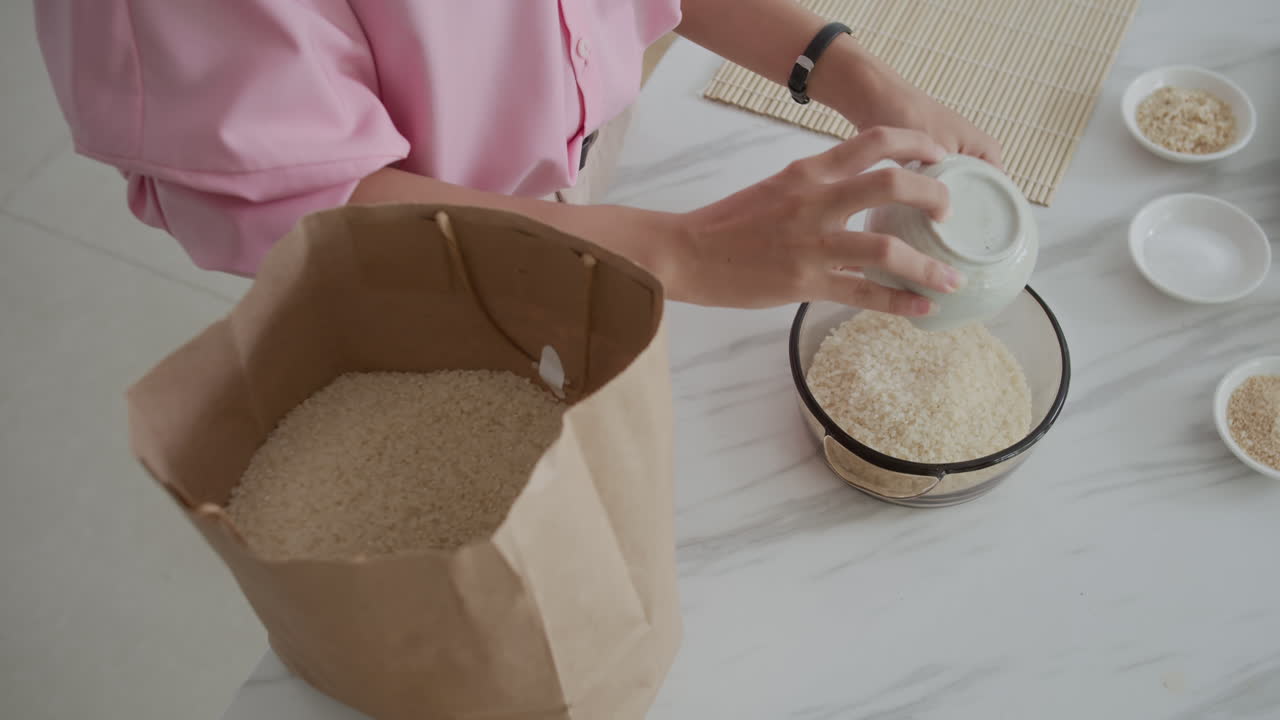 Housewife Pouring Rice to Bowl from Craft Bag at Home