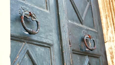 old painted gates with iron knockers