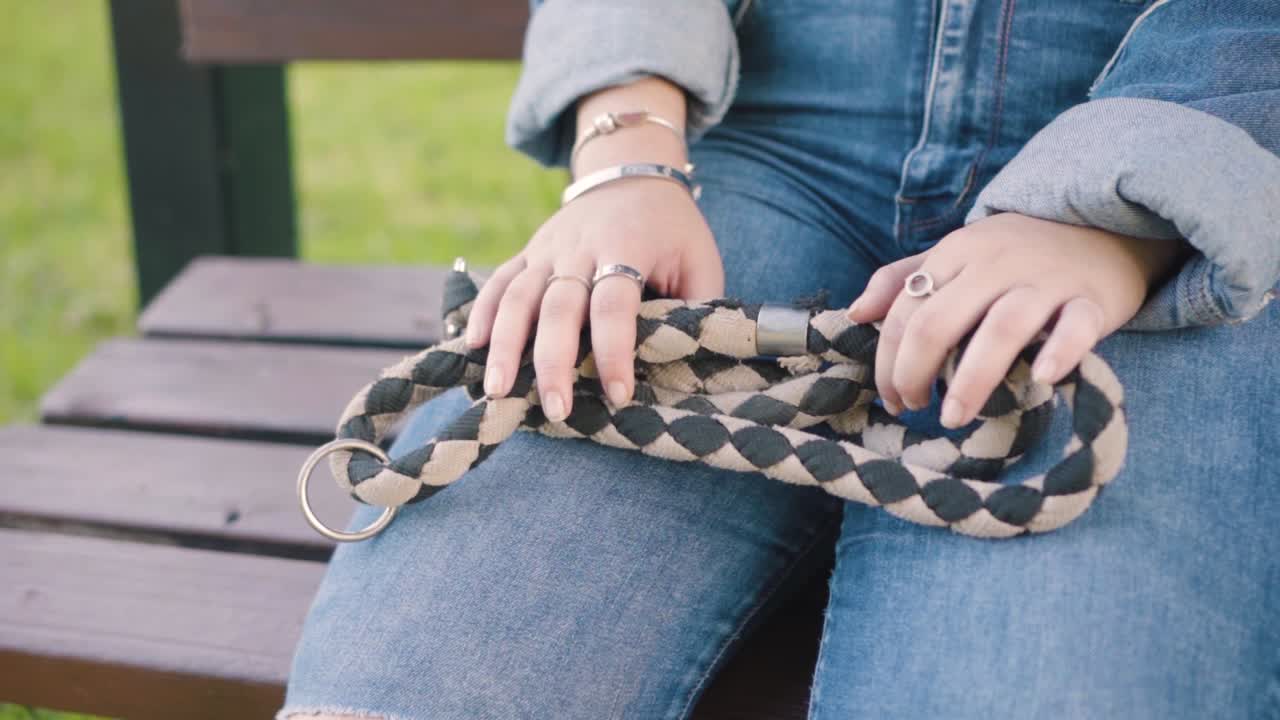 Girl holds a dog's leash