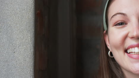 close-up of smiling young caucasian woman in a casual business setting, with copy space