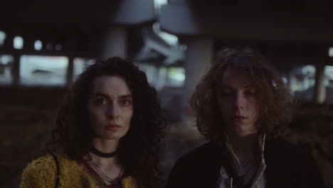 young adults posing under an urban underpass