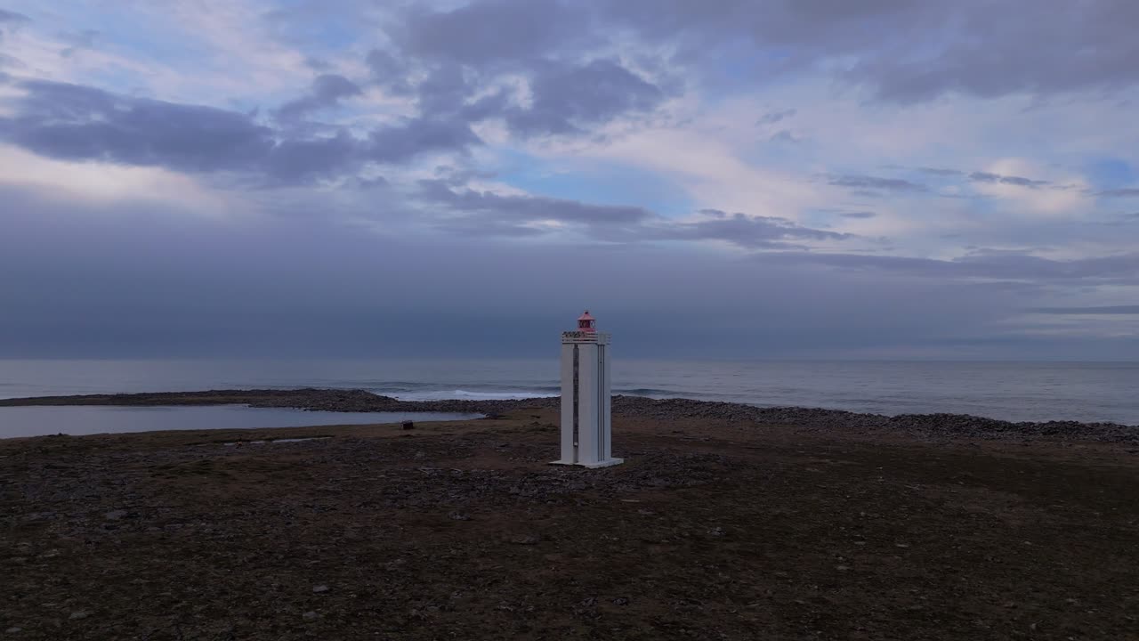 Iconic light house at Melrakkaslétta peninsula, Raufarhöfn, the most northerly peninsula in Iceland. Drone aerial rotate overlooking the Arctic Circle