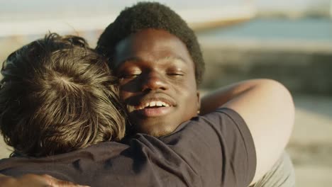 happy african american man using wheelchair greeting friend