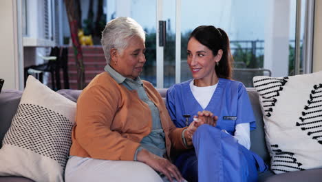 nurse providing care and support to an elderly woman at home