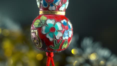 dreamy chinese new year symbol ornament, oriental decoration, traditional red hanging lantern ball, colorful and glowing depth of field, smooth close-up cinematic pan left shot 4k video