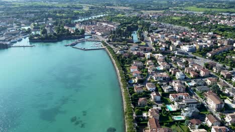 high angle aerial over shoreline of peschiera del garda lake, verona, italy