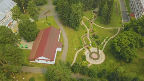 newly-wedded-couple-in-green-park-with-stream-upper-view