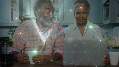Animation-of-networks-of-connections-over-senior-couple-using-laptop