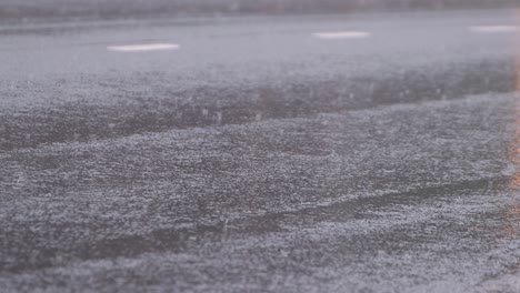 vertical rays of reflection of headlights of moving cars. its raining.