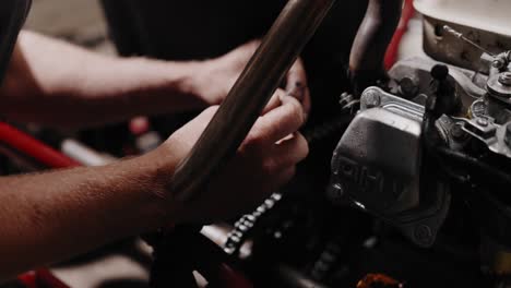 Extreme-close-shot-of-mechanic-putting-a-cable-tie-on-a-chain-to-measure-the-right-length