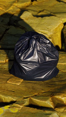 a black garbage bag on a stone surface