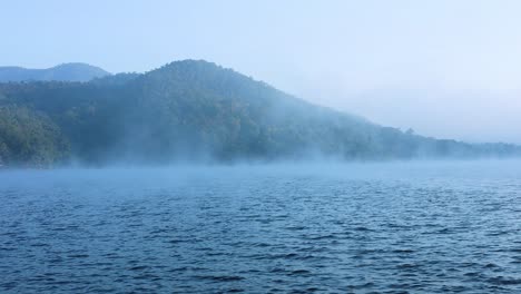 foggy river with mountain backdrop in chiang mai