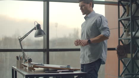 architect man sits at drafting table in modern industrial office during the day. architect working on blueprint with spesial tools and pencil close up. male architect at work only hands with ruler and pencil. design of the house. engineer. tools for drawing. creating a drawing.