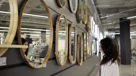 a customer looks at a bathroom mirror in a furniture store creating a design in the house a customer looks at a bathroom mirror in a furniture store creating a design in the house