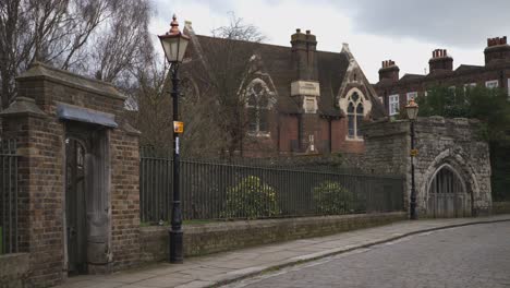 stone gates in a fence to the rochester cathedral gardens