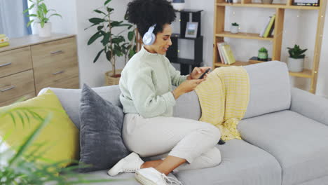 dance, phone and music with woman on sofa