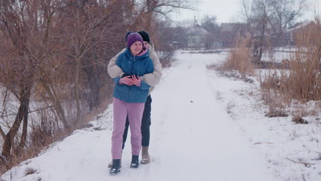couple hugging on a snowy path