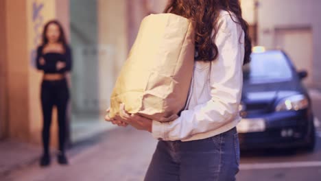 woman carrying shopping bag at night