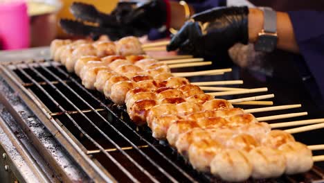 sausages being grilled at a bangkok street market