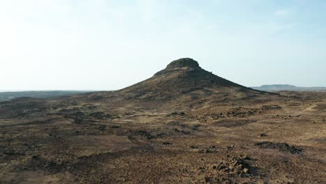 aerial flyover of arid region landscape with mountain, india