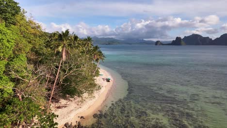 aerial view of las cabañas beach in palawan, philippines, featuring turquoise waters, white sand coastline, lush greenery, boats anchored near shore, and people enjoying the tropical beach environment