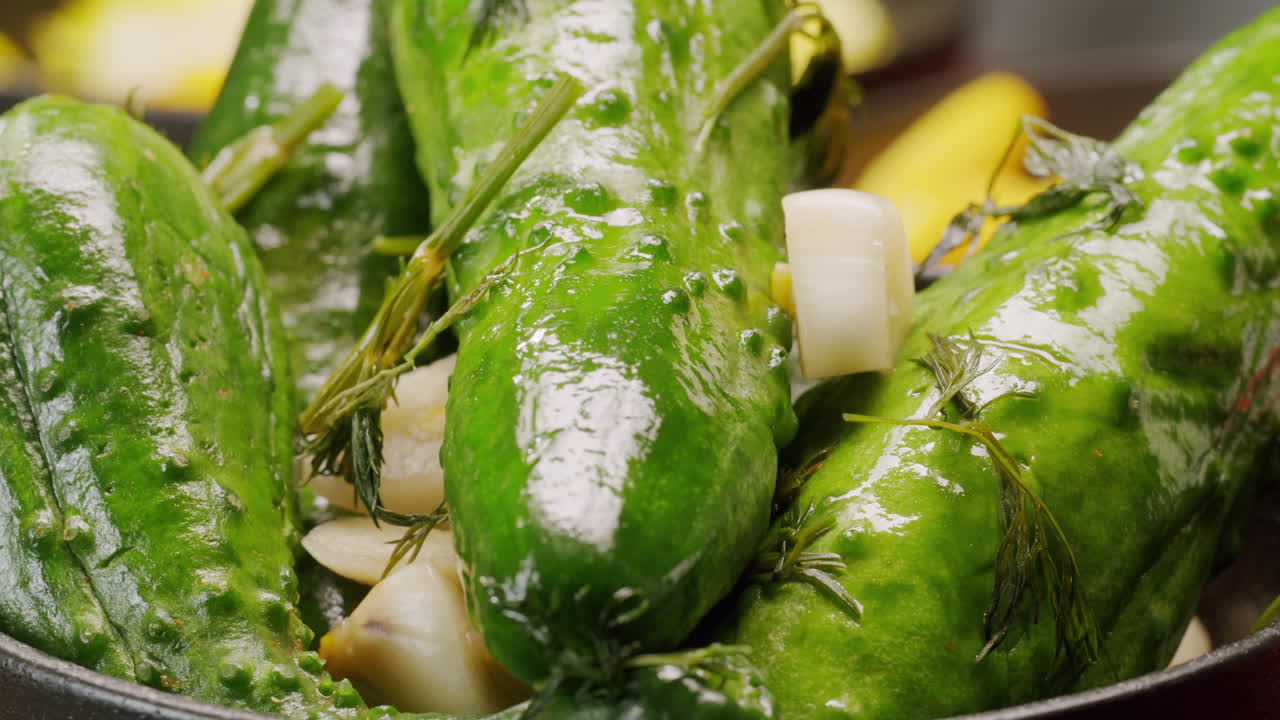 Close-up of fermented cucumbers with garlic and dill on plate. Preservation of vegetables in glass jars. Fermentation preserved cucumbers with spices. Russian cuisine.