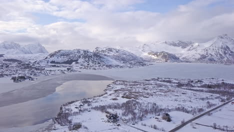 Aerial-of-a-frozen-lake-in-Lofoten-Islands,-Norway