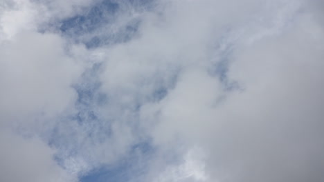 soft, sunlit clouds gently drifting across a bright blue sky