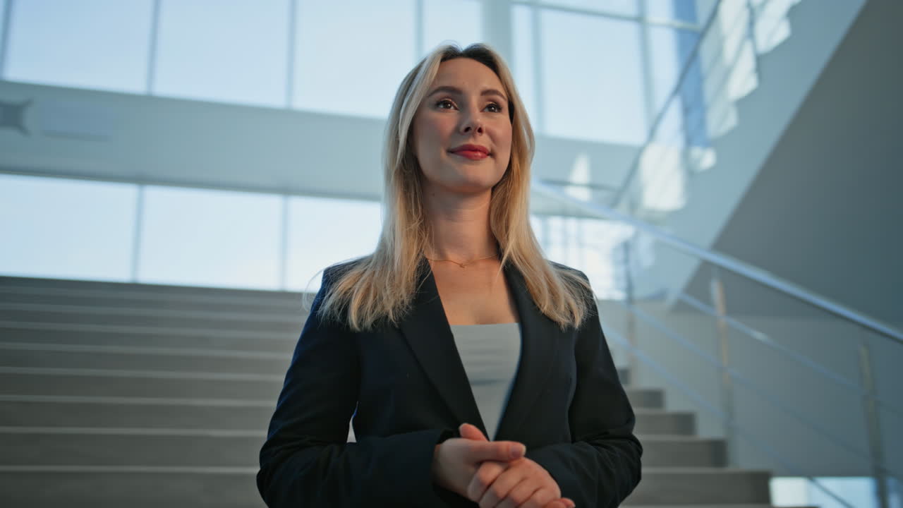 Elegant lady boss standing office stairs looking ahead closeup. Successful woman