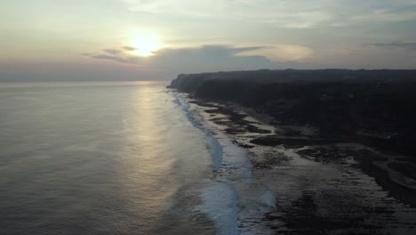 Sunset-on-Uluwatu-Coastline-in-Bali,-Indonesia---Aerial-with-Copy-Space