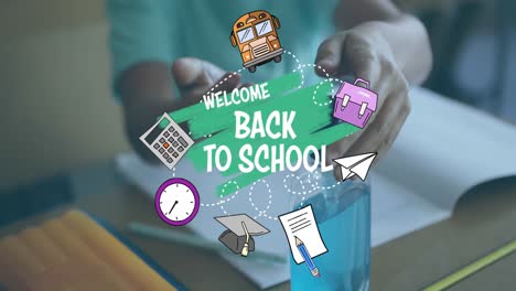 animation of words welcome back to school over boy disinfecting his hands