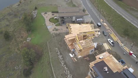 an aerial drone shot of a house overlooking a lake being constructed