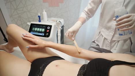 laser epilation - hair removal procedure. flash of diode laser hair removal, beautician removes hair on beautiful female legs, hair removal for smooth skin, laser procedure at beauty studio or clinic, body care epilation treatment.