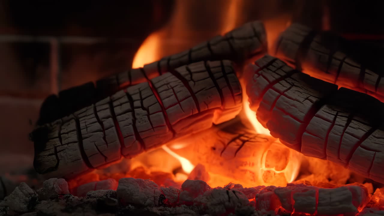 Close-up of Burning Logs and Embers in a Fireplace