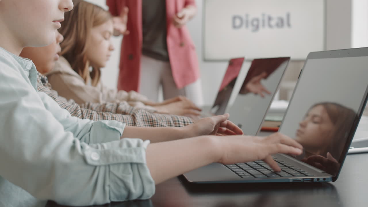 Children Typing on Laptops on Lesson