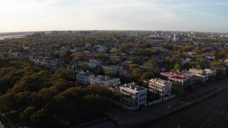 Super-wide-reverse-pullback-aerial-shot-of-historic-Charleston,-South-Carolina-at-sunset