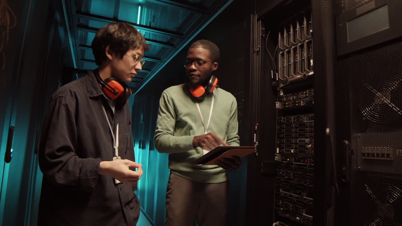 Two IT Engineers Having Conversation in Data Center