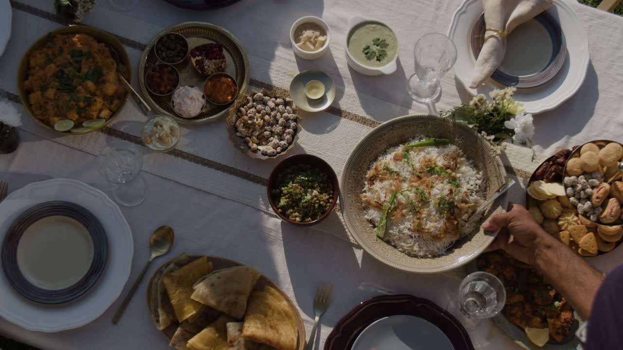 Overhead view of a lavish Indian meal spread on a dining table