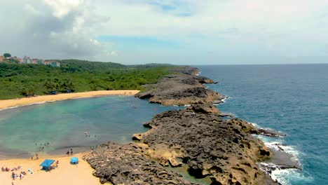 people enjoying mar chiquita beach in tierras nuevas poniente, puerto rico