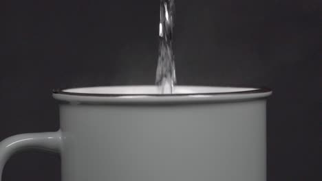 filling cup with hot water with vapour, slow motion 4k