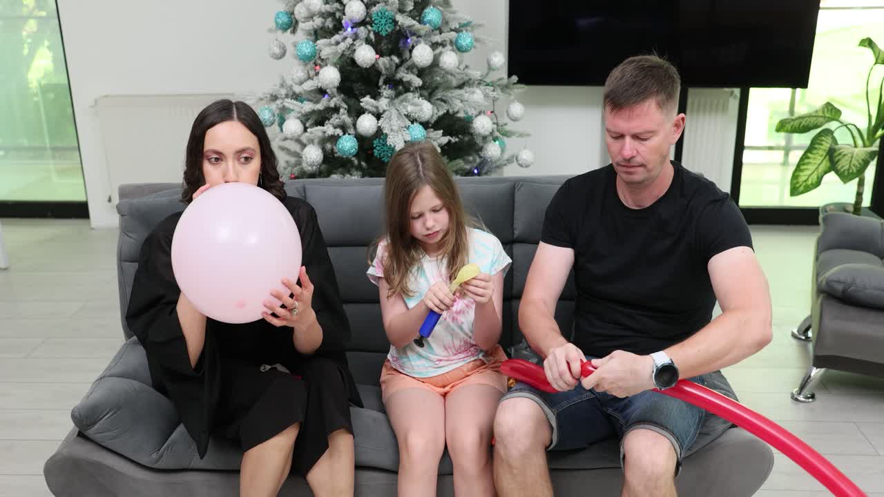 Family celebrating with balloons at Christmas