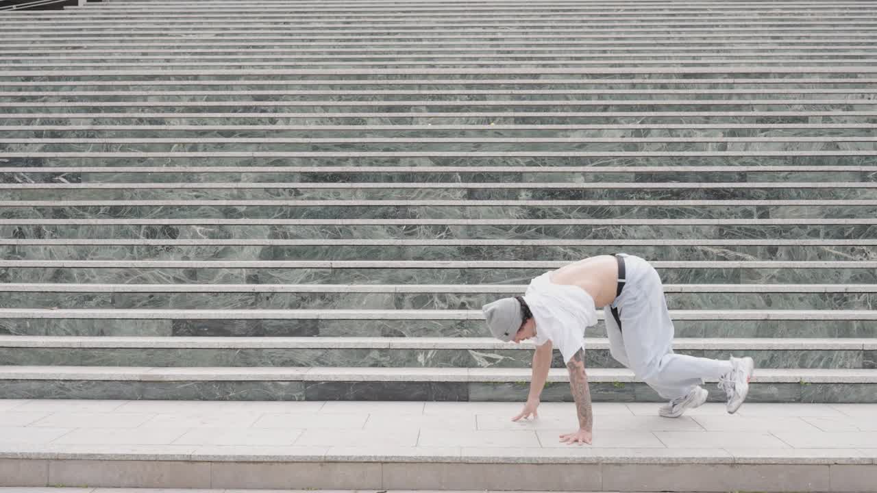 Breakdancer performing various moves on urban steps